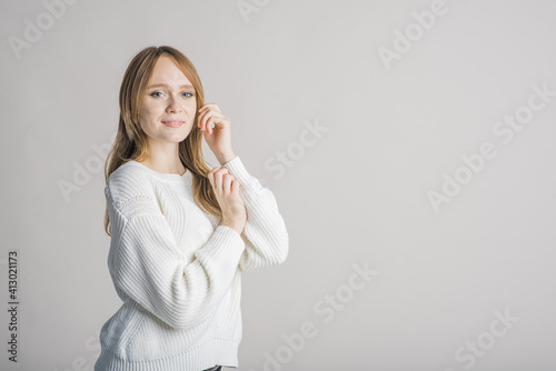 Beautiful young girl on a white background in the studio with a place for writing the text cute smiling