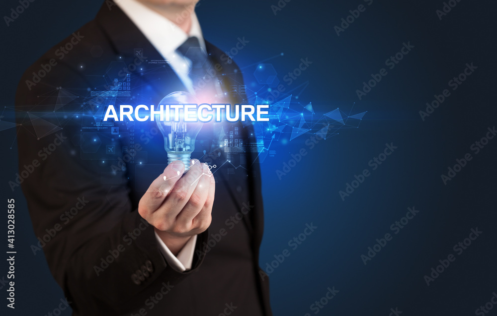 Obraz premium Businessman holding light bulb with ARCHITECTURE inscription, innovative technology concept