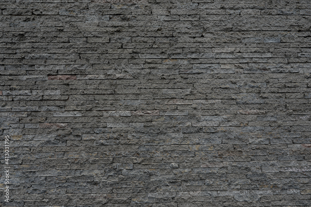 Grey brick stone wall with cracked and uneven background, space for text, no people and horizontal Grey brick stone wall with cracked and uneven background, space for text, no people and horizontal