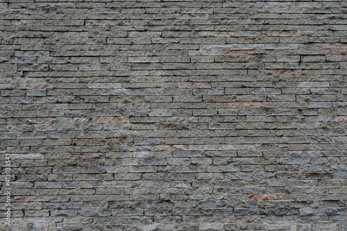 Big brick stone wall with small and uneven background, space for text, no people and horizontal