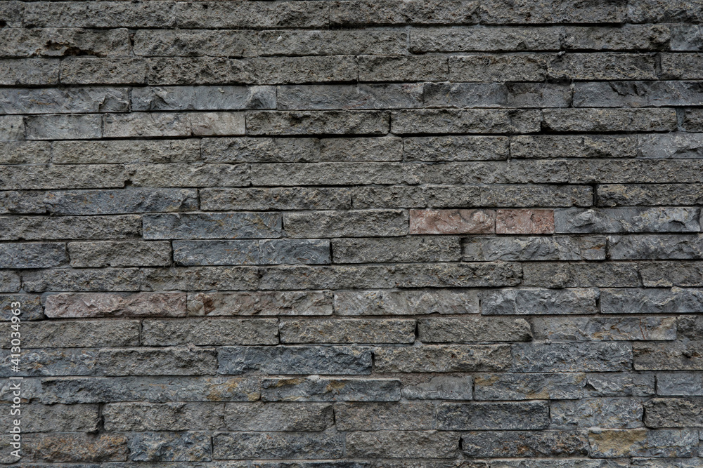 Gray brick wall with uneven and rustic surface, space for text, background as template, no person Gray brick wall with uneven and rustic surface, space for text, background as template, no person
