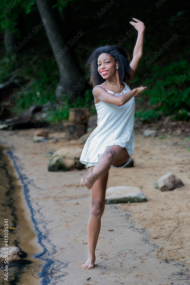 Woman at lake on swing, large boulder, and in water Woman at lake on swing, large boulder, and in water