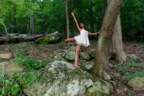 Woman  at lake on swing  large boulder  and in water