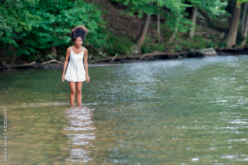 Woman at lake on swing, large boulder, and in water Woman at lake on swing, large boulder, and in water