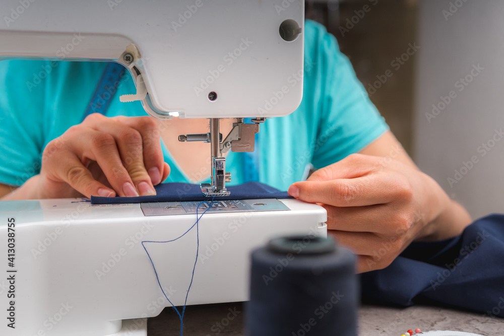 Young woman at her sewing machine