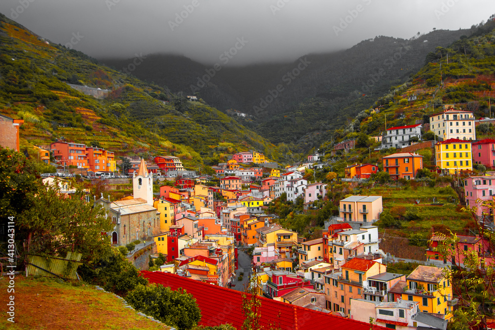 Riomaggiore, Liguria Italy. Traditional typical Italian village in National park Cinque Terre, colorful multicolored buildings houses on mountain