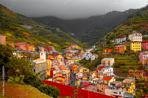 Riomaggiore, Liguria Italy. Traditional typical Italian village in National park Cinque Terre, colorful multicolored buildings houses on mountain © Giampaolo