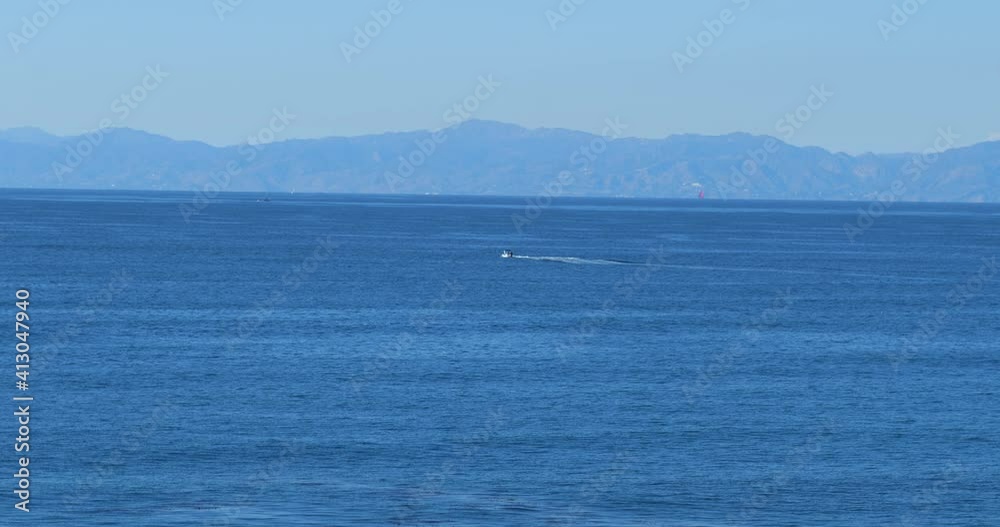 A fast powerboat moving through the Pacific Ocean on a summer day A fast powerboat moving through the Pacific Ocean on a summer day