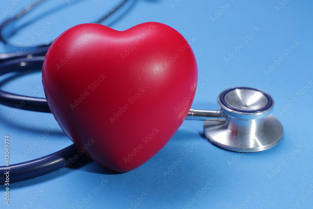 Red heart shape and stethoscope on blue background Red heart shape and stethoscope on blue background