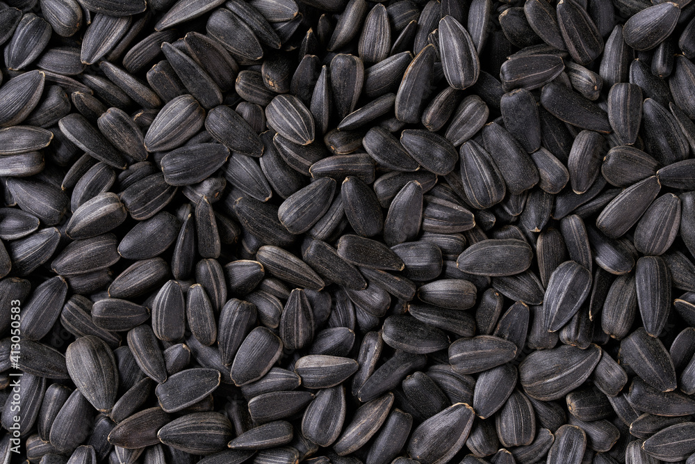 black sunflowers seeds texture background, top view.