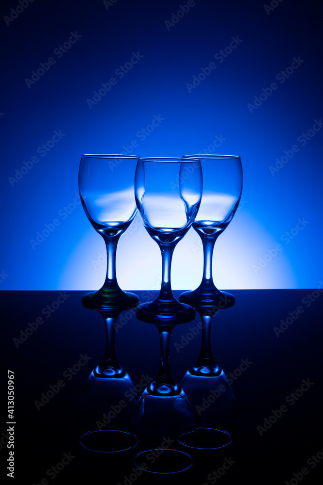 Empty wine glasses with blue background Empty wine glasses with blue background