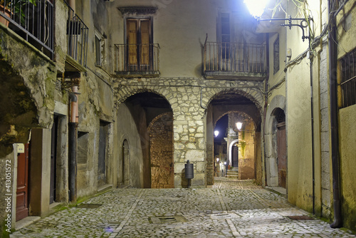 Fototapeta Naklejka Na Ścianę i Meble -  A narrow street between the old houses of Guardia Sanframondi, a medieval village in the province of Salerno, Italy.