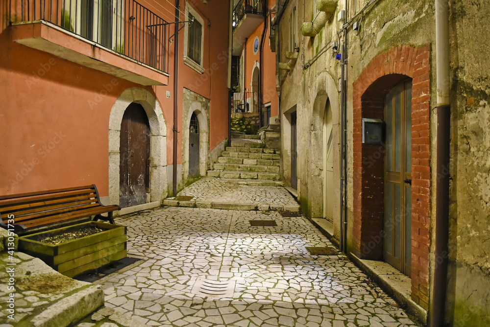 A narrow street between the old houses of Guardia Sanframondi, a medieval village in the province of Salerno, Italy.