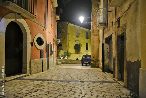 A narrow street between the old houses of Guardia Sanframondi, a medieval village in the province of Salerno, Italy. photo