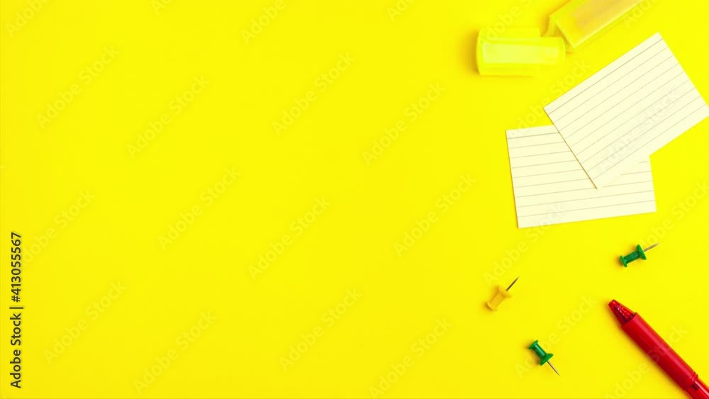 Stop motion animation of pen, notepad, marker, push pins, paper clip pencils on yellow background. Flat lay top view. Education template back to school and online study concept with copy space
