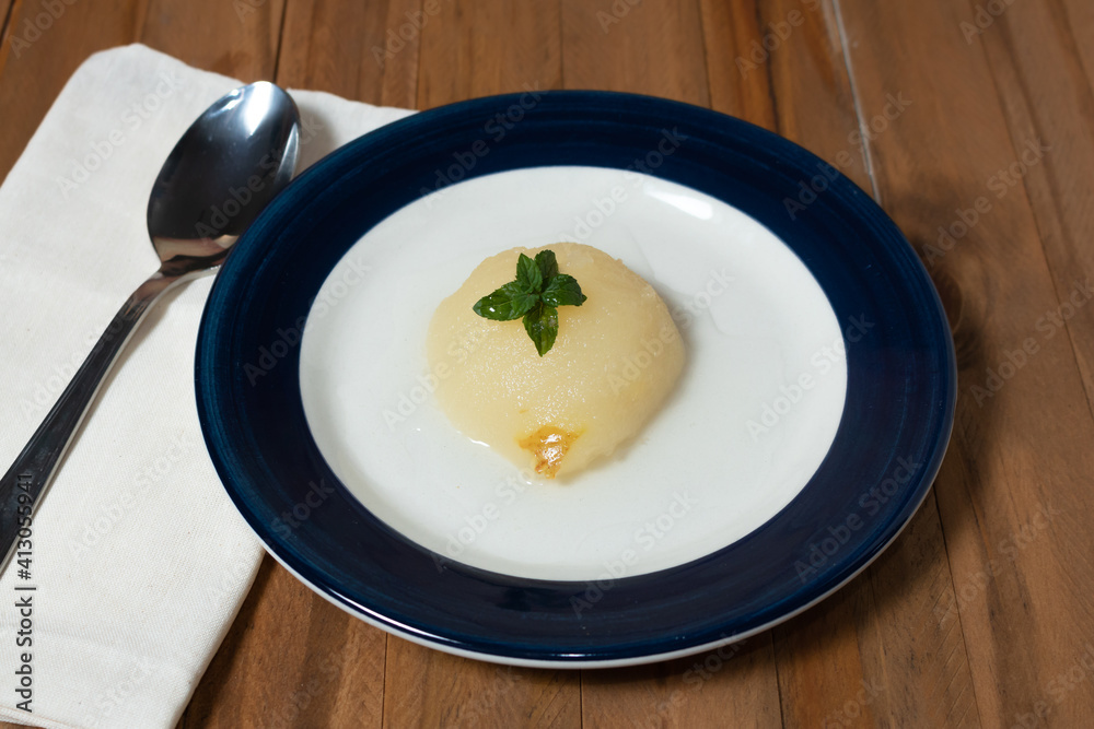 Fresh half Pears Served with sweet syrup. Wooden table background. Fresh half Pears Served with sweet syrup. Wooden table background.