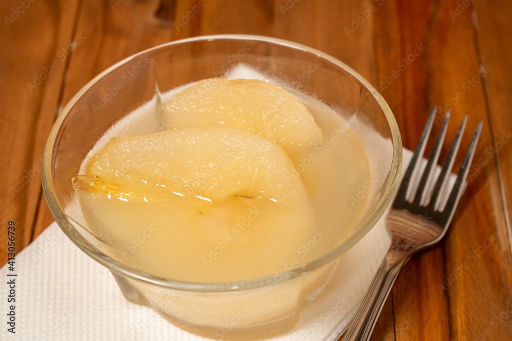 Fresh half Pears Served with sweet syrup. Wooden table background. Fresh half Pears Served with sweet syrup. Wooden table background.