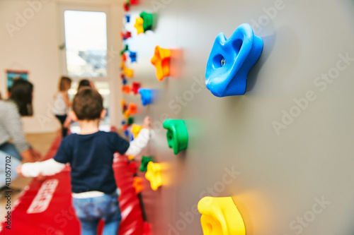 Quadro su tela Wall with climbing grips in daycare or kindergarten, activity for little childre