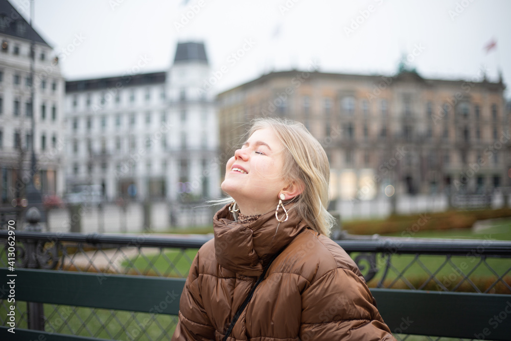Teenage girl raises her head and closes her eyes, breathes deeply the air, she is happy and relaxed Teenage girl raises her head and closes her eyes, breathes deeply the air, she is happy and relaxed
