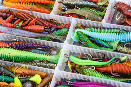 A large fisherman's tackle box fully stocked with lures and gear for fishing.fishing lures and accessories in the box background.