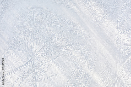 Snow-covered ice with ski tracks top aerial view