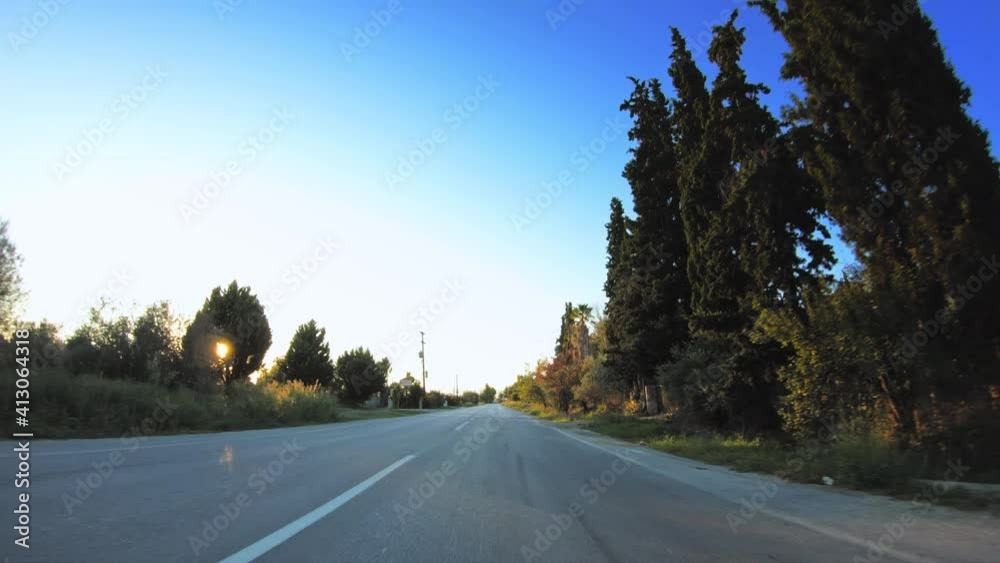 Countryside POV travel shot, green nature with golden sunshine, car drive asphalt road Countryside POV travel shot, green nature with golden sunshine, car drive asphalt road