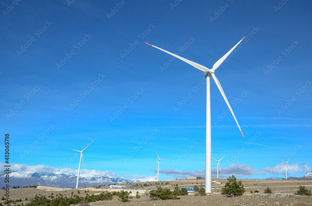 Wind farm on the mountain. Wind turbines on the hill. Renewable energy. Wind park. Wind farm on the mountain. Wind turbines on the hill. Renewable energy. Wind park.