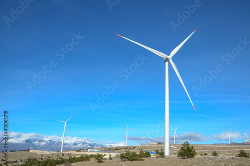 Wind farm on the mountain. Wind turbines on the hill. Renewable energy. Wind park.