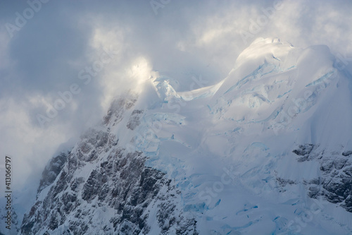 Antarctica. Paradise Harbor. Snowy mountains and clouds at sunrise.