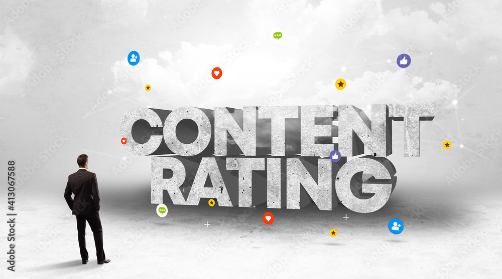 Young businessman standing in front of CONTENT RATING inscription, social media concept Young businessman standing in front of CONTENT RATING inscription, social media concept