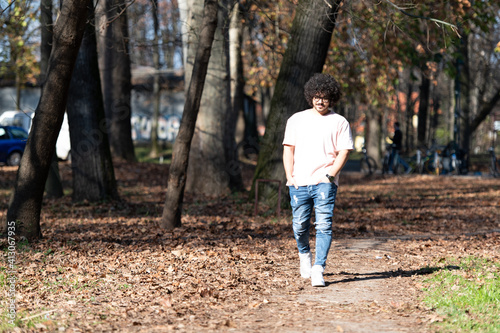 Young Man Walking in Autumn Forest