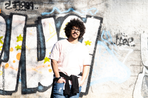 Trendy Handsome Man Posing at Graffiti Wall Outside © Jale Ibrak