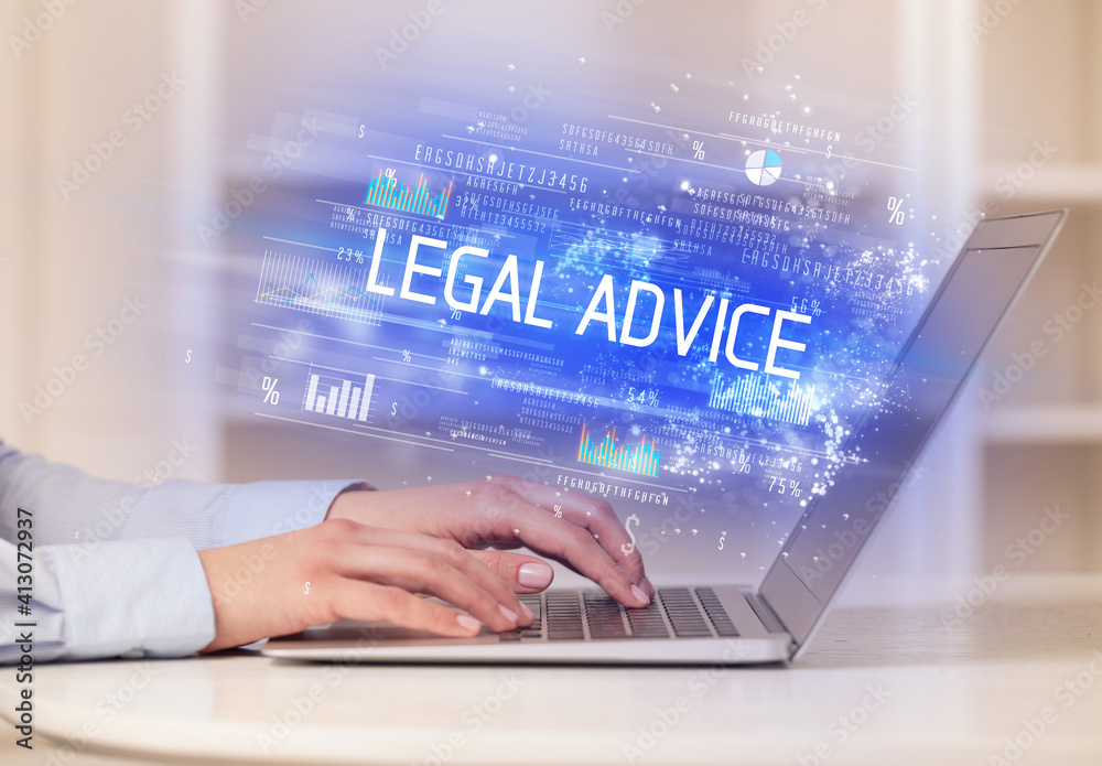 Closeup of businessman hands working on laptop with LEGAL ADVICE inscription, succesfull business concept