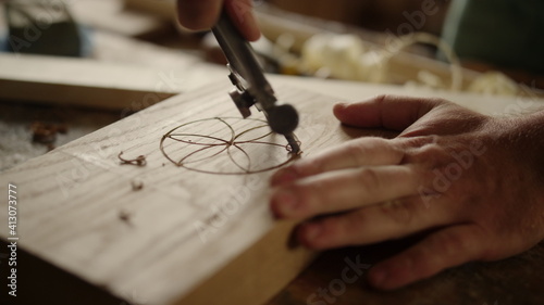 Fotografie Man making pattern on wooden product indoors