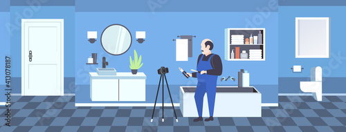 handyman worker with screwdriver and cutting pliers blogger recording online video with digital camera on tripod social network blogging concept modern bathroom interior full length horizontal vector