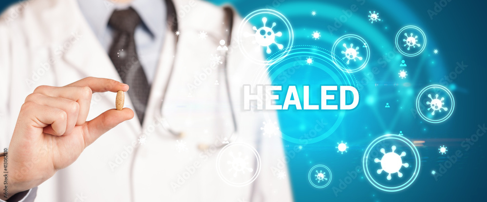 Doctor giving pill with HEALED inscription, coronavirus concept Doctor giving pill with HEALED inscription, coronavirus concept