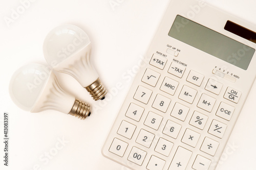 Concept of electricity charge (light bulb and calculator)