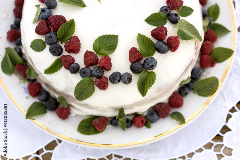 cake with berries on a white tablecloth close up