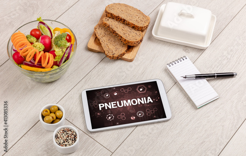 Healthy Tablet Pc compostion with PNEUMONIA inscription, immune system boost concept