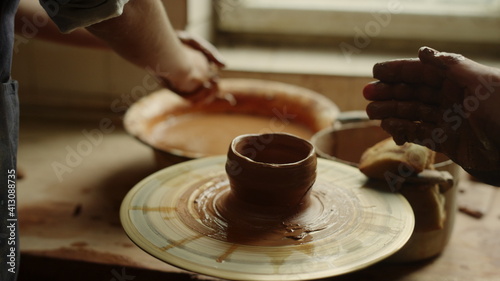 Man and woman sculpting in pottery. Girl preparing to modeling in workshop