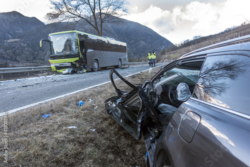 Violent head-on collision between a bus and a car traveling in the opposite direction at the end of the day. A victim due to high speed or drunk driving car crash at sunset or sunrise. 