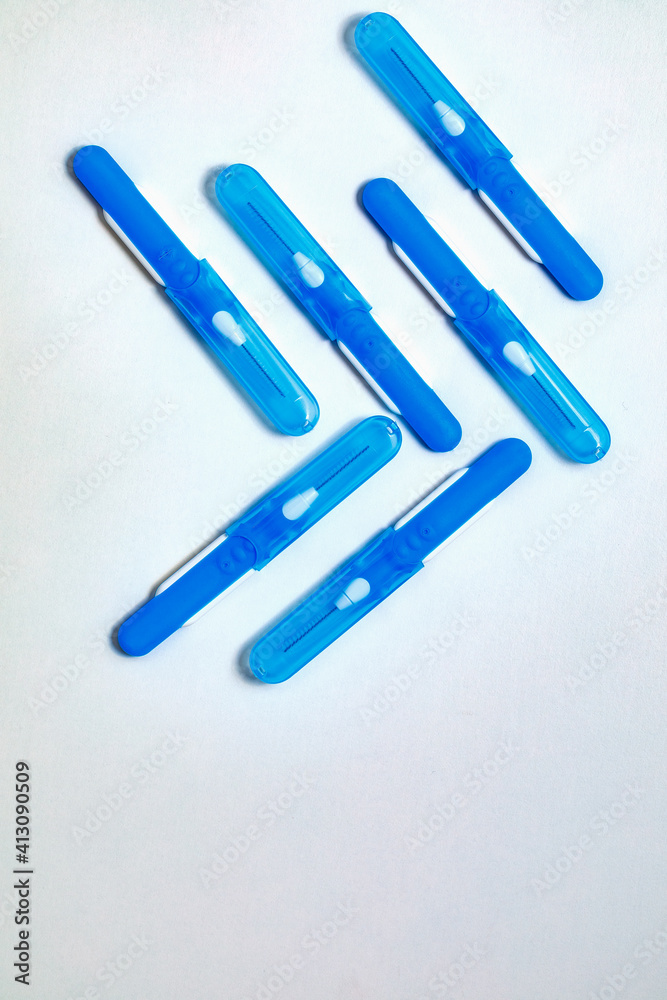 Fototapeta premium Blue with white interdental brushes. Oral hygiene. Brush your teeth thoroughly. Interdental-Sticks. Copy space
