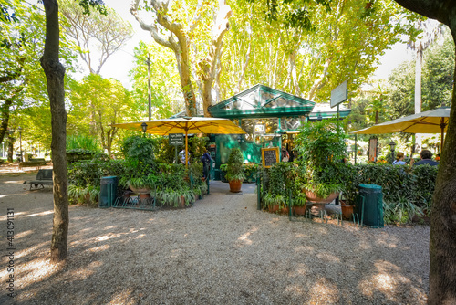 Photography A small snack shop with a lush garden patio inside the Borghese Gardens in Rome,