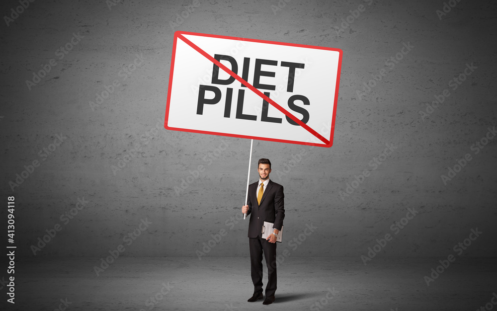 business person holding a traffic sign with DIET PILLS inscription, new idea concept business person holding a traffic sign with DIET PILLS inscription, new idea concept