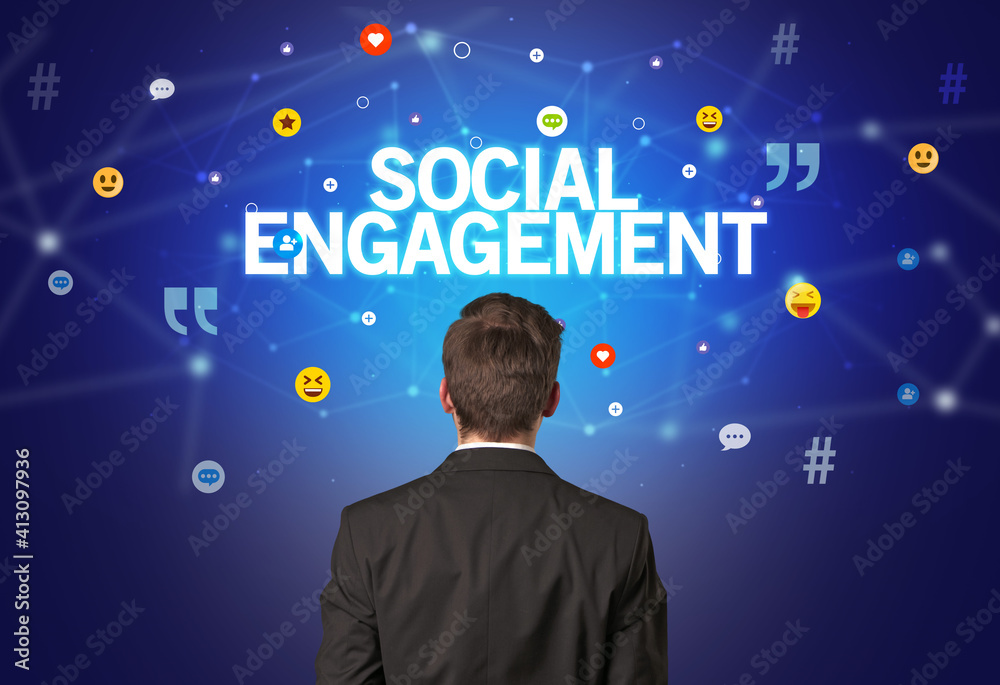 Rear view of a businessman with SOCIAL ENGAGEMENT inscription, social networking concept Rear view of a businessman with SOCIAL ENGAGEMENT inscription, social networking concept