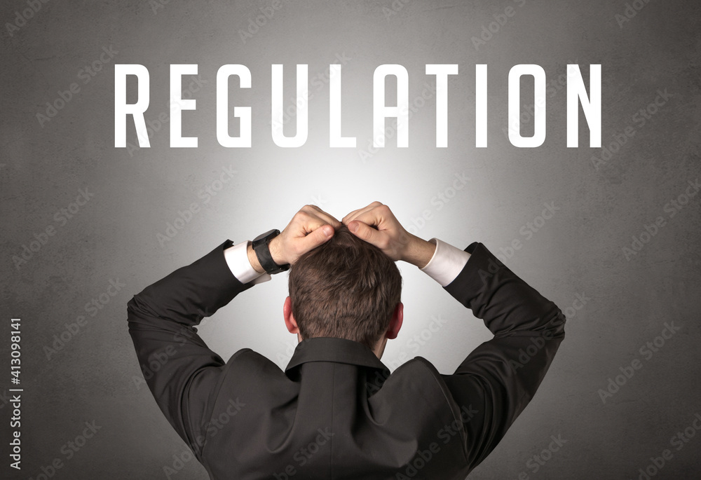 Rear view of a businessman with REGULATION inscription, cyber security concept