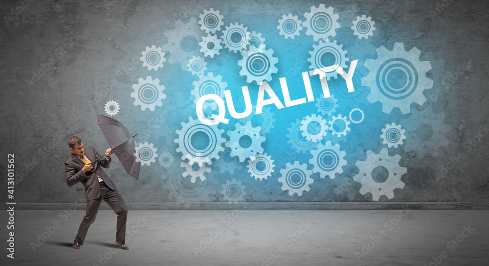 Businessman defending with umbrella from QUALITY inscription, technology concept Businessman defending with umbrella from QUALITY inscription, technology concept