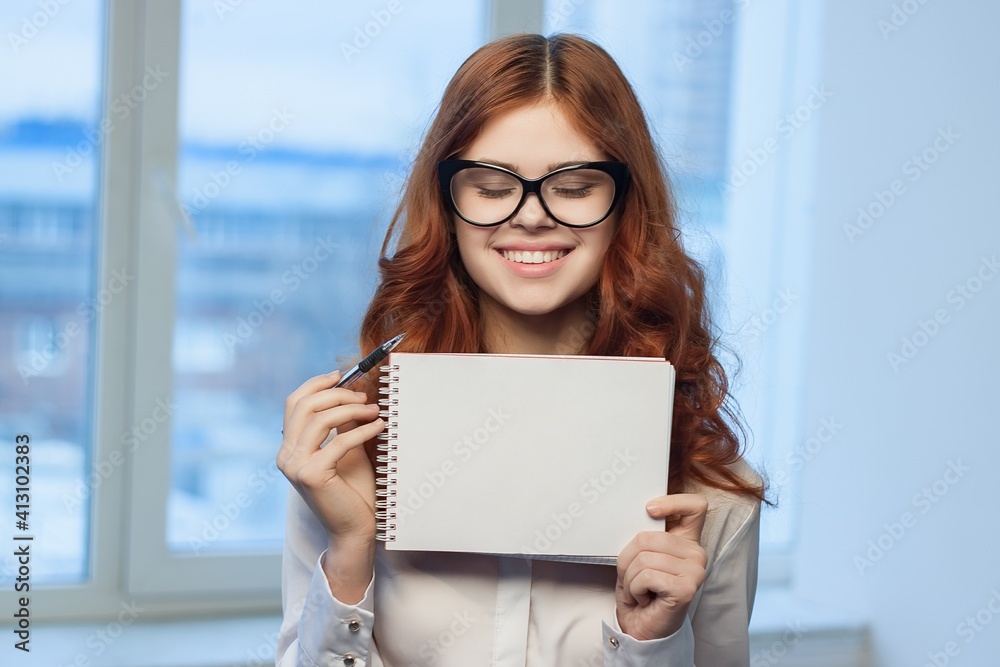 Business woman in white shirt with notebook in hands of office professionals Business woman in white shirt with notebook in hands of office professionals