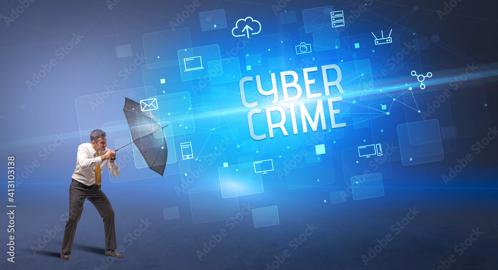 Businessman defending with umbrella from cyber attack and CYBER CRIME inscription, online security concept Businessman defending with umbrella from cyber attack and CYBER CRIME inscription, online security concept