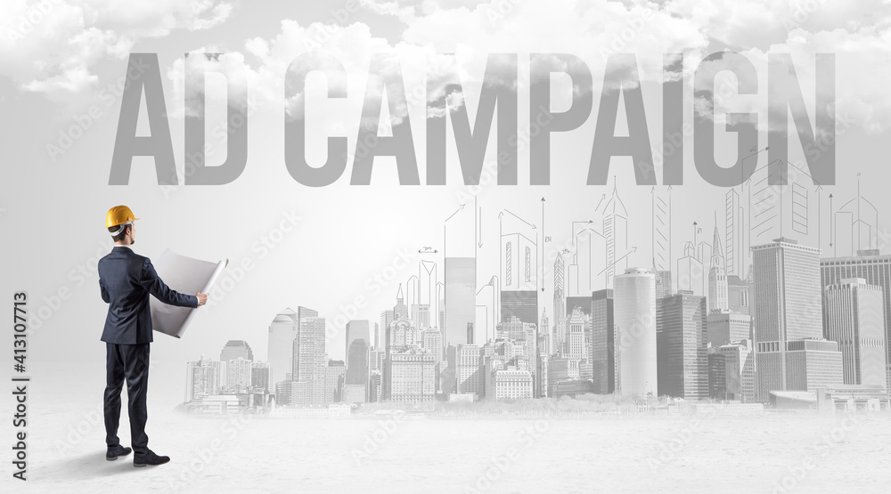 Young businessman with hard hat and AD CAMPAIGN inscription, new business opportunity concept Young businessman with hard hat and AD CAMPAIGN inscription, new business opportunity concept